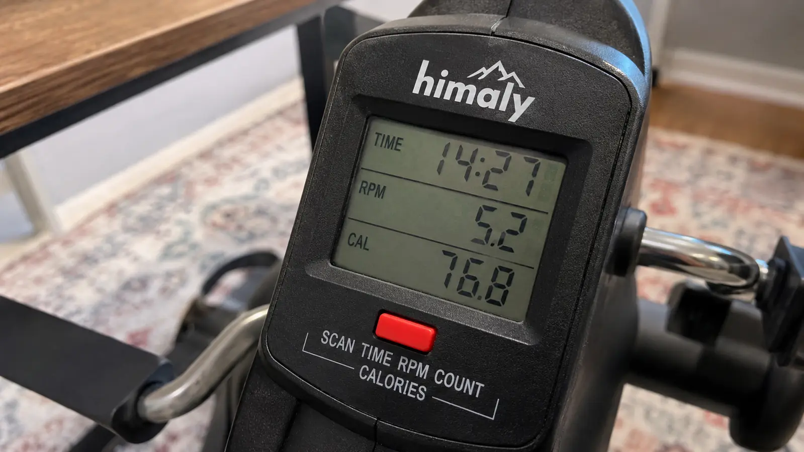 Close-up of the LCD screen on the pedal exerciser showing time, RPM, and calories during a work session